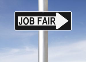 Outdoor one way sign indicating a job fair.