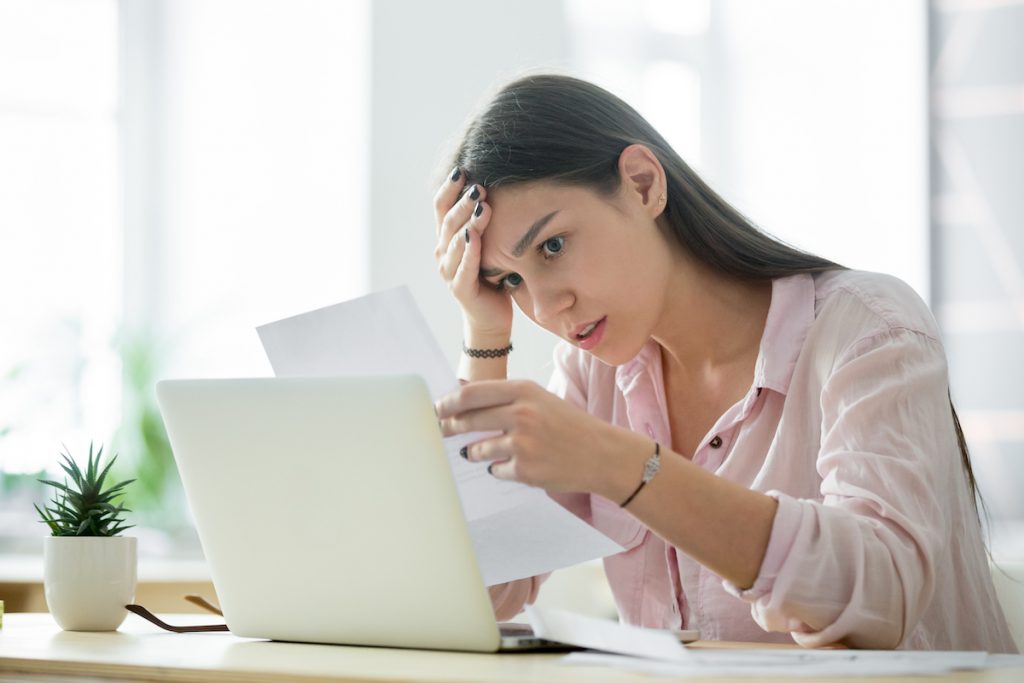 woman looking frustrated at desk